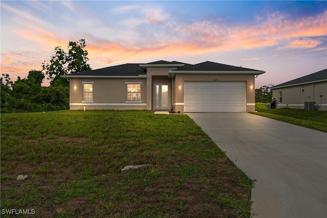 3109 11th St W, Lehigh Acres, FL 33971 - view of front of house featuring stucco siding, concrete driveway, a garage, and a front yard