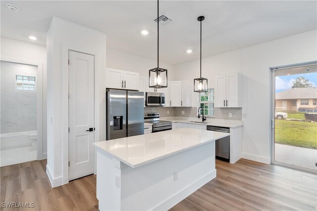 3109 11th St W, Lehigh Acres, FL 33971 - kitchen featuring stainless steel appliances, healthy amount of natural light, white cabinets, and recessed lighting