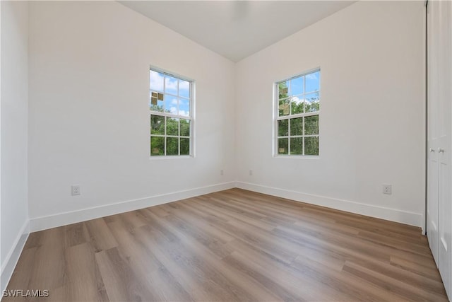 3109 11th St W, Lehigh Acres, FL 33971 - spare room featuring healthy amount of natural light and wood finished floors