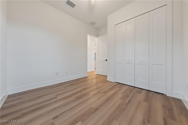 3109 11th St W, Lehigh Acres, FL 33971 - unfurnished bedroom featuring light wood finished floors and a closet