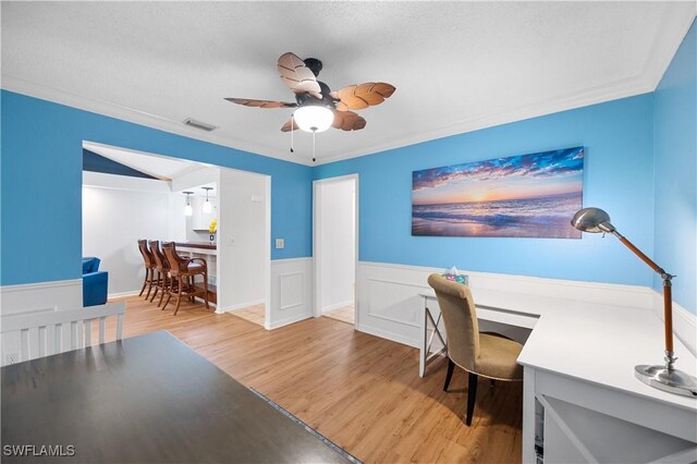 9820 Citadel Ln Unit 202, Bonita Springs, FL 34135 - office space featuring light wood-style flooring, ceiling fan, a wainscoted wall, and crown molding