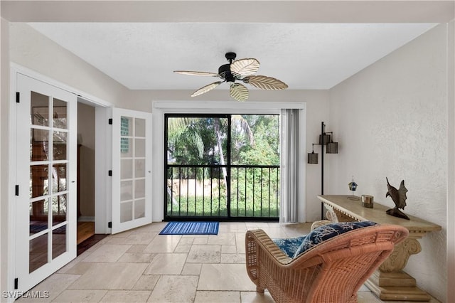 9820 Citadel Ln Unit 202, Bonita Springs, FL 34135 - doorway featuring stone tile flooring, a ceiling fan, and a textured wall