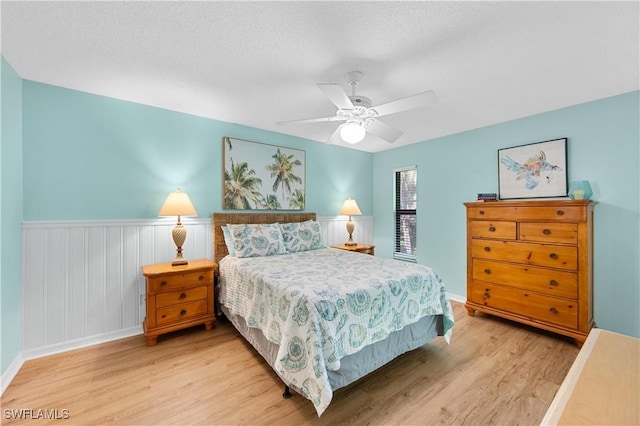 9820 Citadel Ln Unit 202, Bonita Springs, FL 34135 - bedroom with light wood-style flooring, wainscoting, and a ceiling fan