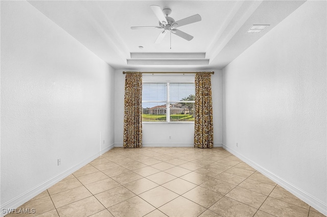14813 Canton Ct, Naples, FL 34114 - empty room with a tray ceiling, a ceiling fan, and light tile patterned floors