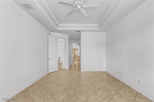 14813 Canton Ct, Naples, FL 34114 - empty room with a raised ceiling, a ceiling fan, and light tile patterned floors