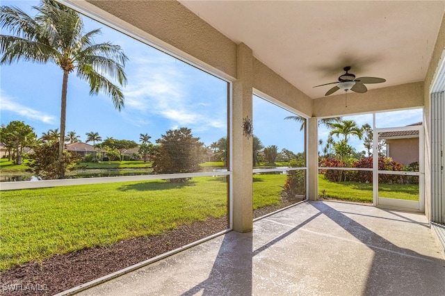 14813 Canton Ct, Naples, FL 34114 - unfurnished sunroom with a ceiling fan and a water view
