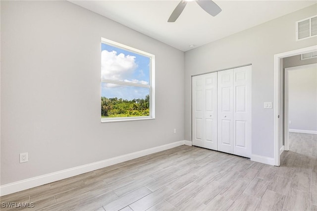1909 Moore Ave, Lehigh Acres, FL 33972 - unfurnished bedroom featuring light wood-style floors, a closet, and ceiling fan