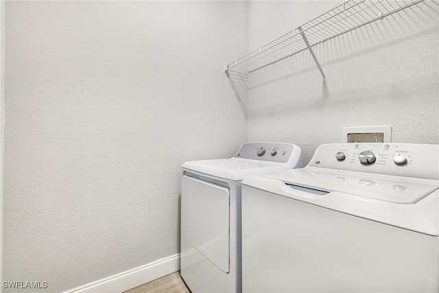 1909 Moore Ave, Lehigh Acres, FL 33972 - washroom with washer and dryer and baseboards