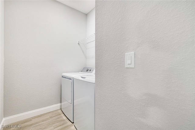 1909 Moore Ave, Lehigh Acres, FL 33972 - washroom with washer and clothes dryer and light wood finished floors