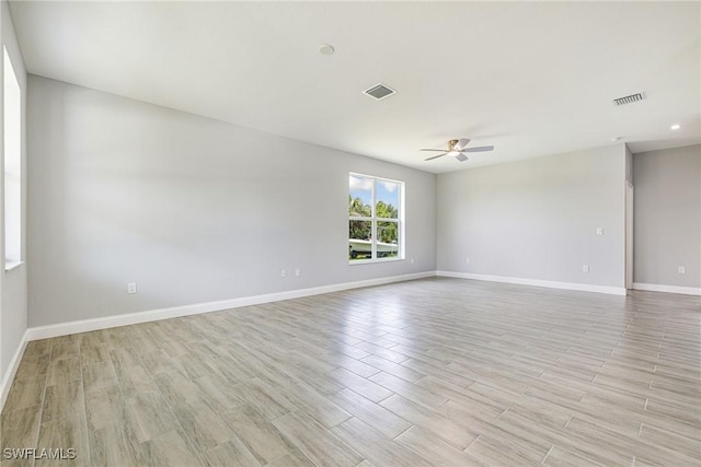 1909 Moore Ave, Lehigh Acres, FL 33972 - spare room with light wood-style floors and ceiling fan