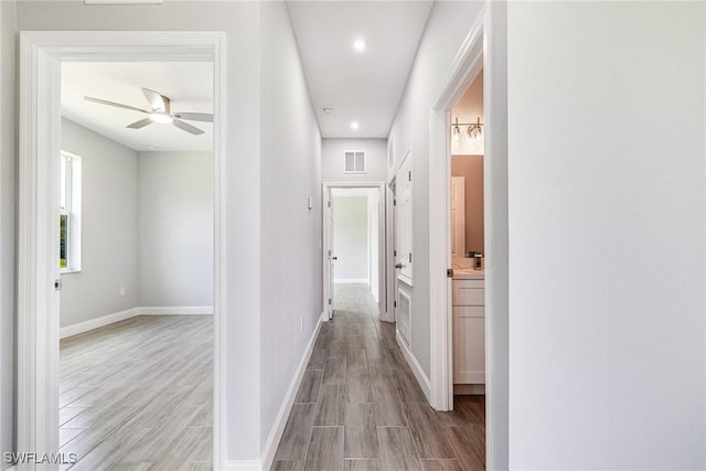 1909 Moore Ave, Lehigh Acres, FL 33972 - corridor featuring light wood-style flooring and recessed lighting