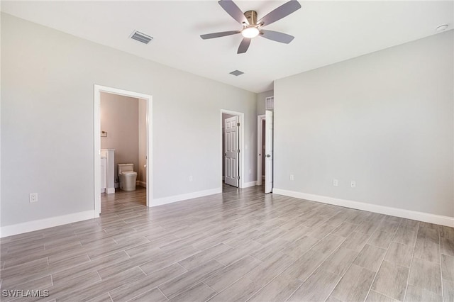 1909 Moore Ave, Lehigh Acres, FL 33972 - unfurnished bedroom with light wood-type flooring, connected bathroom, and a ceiling fan