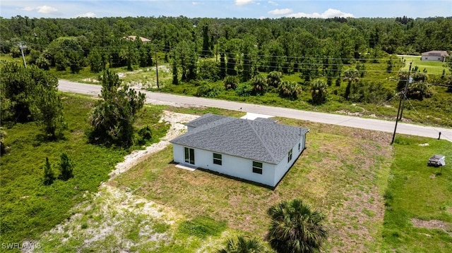 1909 Moore Ave, Lehigh Acres, FL 33972 - aerial view of property and surrounding area with a heavily wooded area