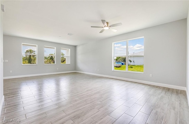 1909 Moore Ave, Lehigh Acres, FL 33972 - unfurnished room featuring a ceiling fan and wood finished floors