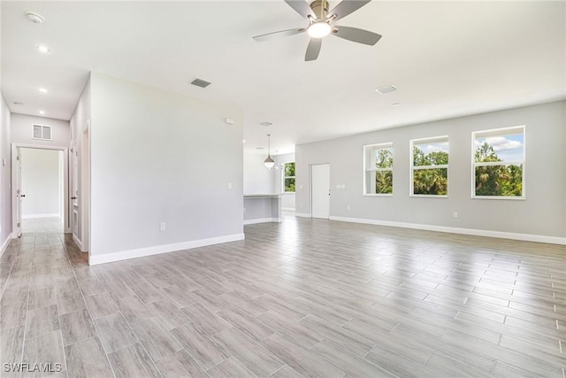 1909 Moore Ave, Lehigh Acres, FL 33972 - unfurnished living room featuring ceiling fan, light wood-type flooring, and recessed lighting