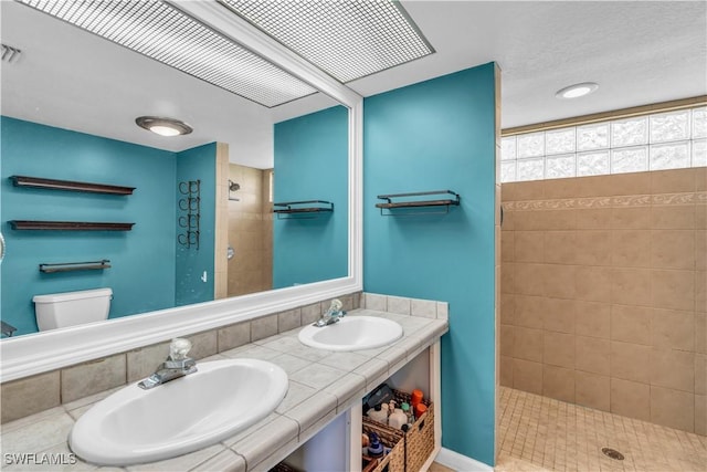 950 Moody Rd Unit 123, North Fort Myers, FL 33903 - bathroom featuring tiled shower and double vanity
