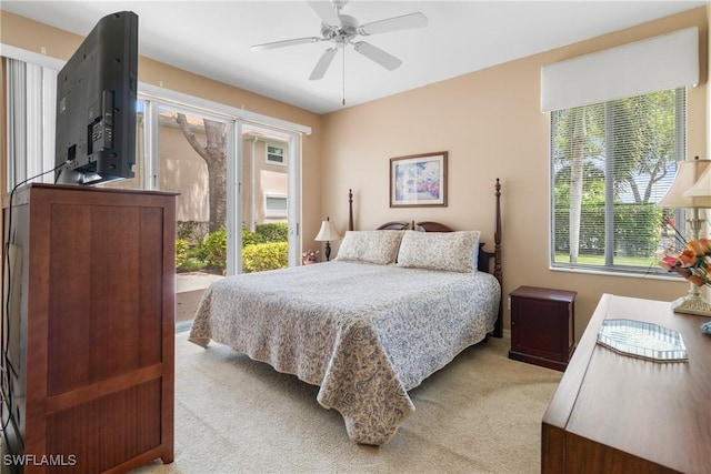 76 4th St Unit 2-102, Bonita Springs, FL 34134 - bedroom featuring light colored carpet, multiple windows, and a ceiling fan