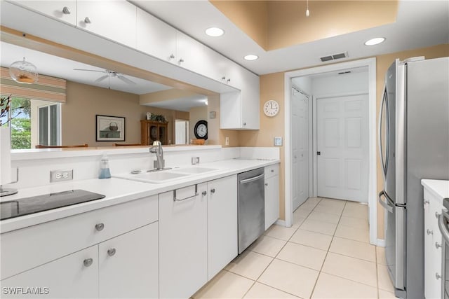 76 4th St Unit 2-102, Bonita Springs, FL 34134 - kitchen featuring appliances with stainless steel finishes, recessed lighting, white cabinetry, light tile patterned flooring, and light countertops