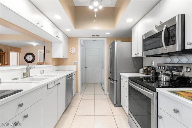 76 4th St Unit 2-102, Bonita Springs, FL 34134 - kitchen featuring stainless steel appliances, recessed lighting, white cabinets, light countertops, and light tile patterned floors