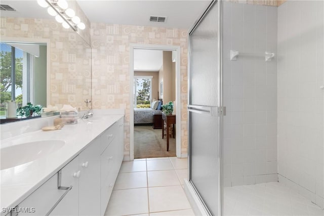 76 4th St Unit 2-102, Bonita Springs, FL 34134 - bathroom with double vanity, ensuite bathroom, a stall shower, wallpapered walls, and tile patterned flooring