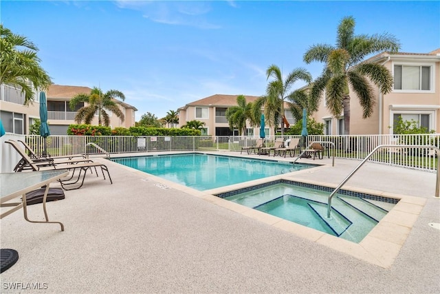 76 4th St Unit 2-102, Bonita Springs, FL 34134 - community pool featuring a community hot tub and a patio