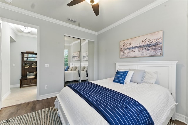 6899 Del Mar Ter, Naples, FL 34105 - bedroom with wood finished floors, ornamental molding, a closet, and a ceiling fan