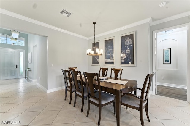 6899 Del Mar Ter, Naples, FL 34105 - dining room featuring light tile patterned flooring, a chandelier, and ornamental molding
