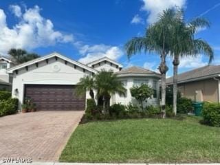6899 Del Mar Ter, Naples, FL 34105 - ranch-style home featuring a garage, driveway, and a front lawn