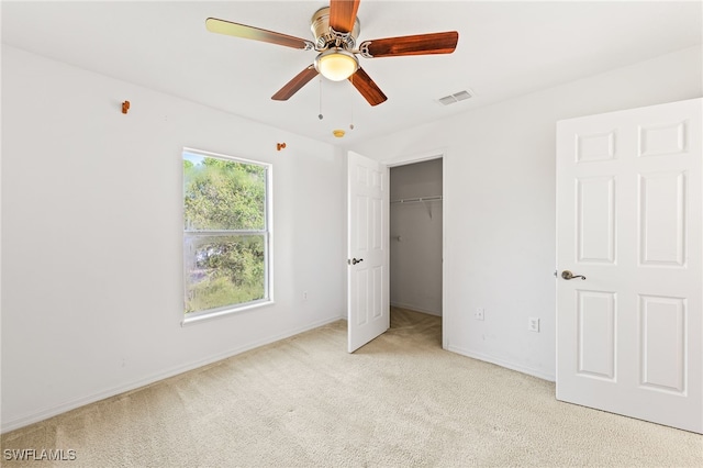 312 Lenz Ave S, Lehigh Acres, FL 33974 - unfurnished bedroom with carpet floors, a walk in closet, ceiling fan, and a closet