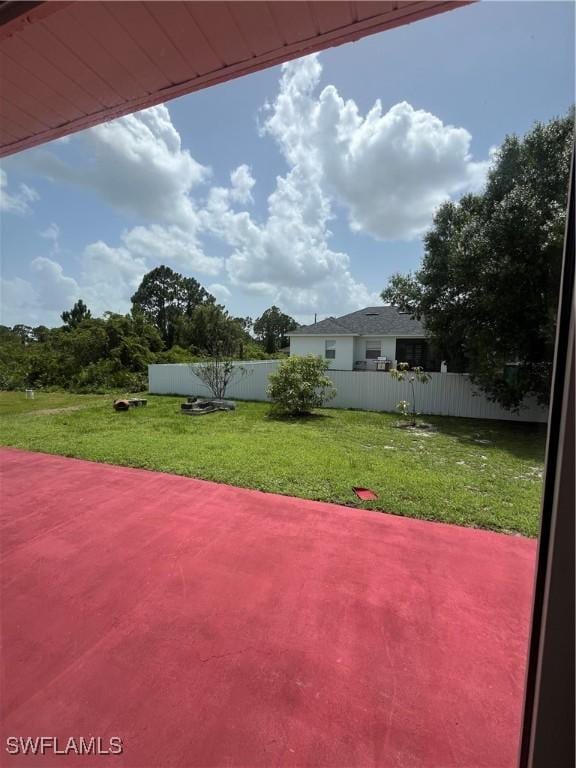 312 Lenz Ave S, Lehigh Acres, FL 33974 - fenced backyard with a patio