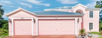 312 Lenz Ave S, Lehigh Acres, FL 33974 - view of front of house with a garage, driveway, and stucco siding