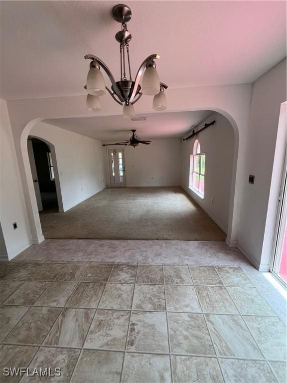 312 Lenz Ave S, Lehigh Acres, FL 33974 - empty room featuring arched walkways, light carpet, and ceiling fan