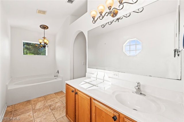 312 Lenz Ave S, Lehigh Acres, FL 33974 - bathroom with a bath, a chandelier, and vanity