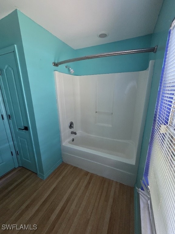 3022 34th St SW, Lehigh Acres, FL 33976 - bathroom with washtub / shower combination and wood finished floors