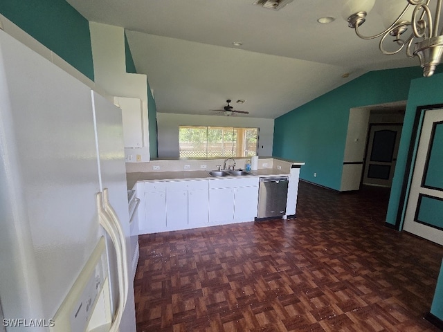 3022 34th St SW, Lehigh Acres, FL 33976 - kitchen featuring freestanding refrigerator, stainless steel dishwasher, lofted ceiling, a peninsula, and white cabinetry
