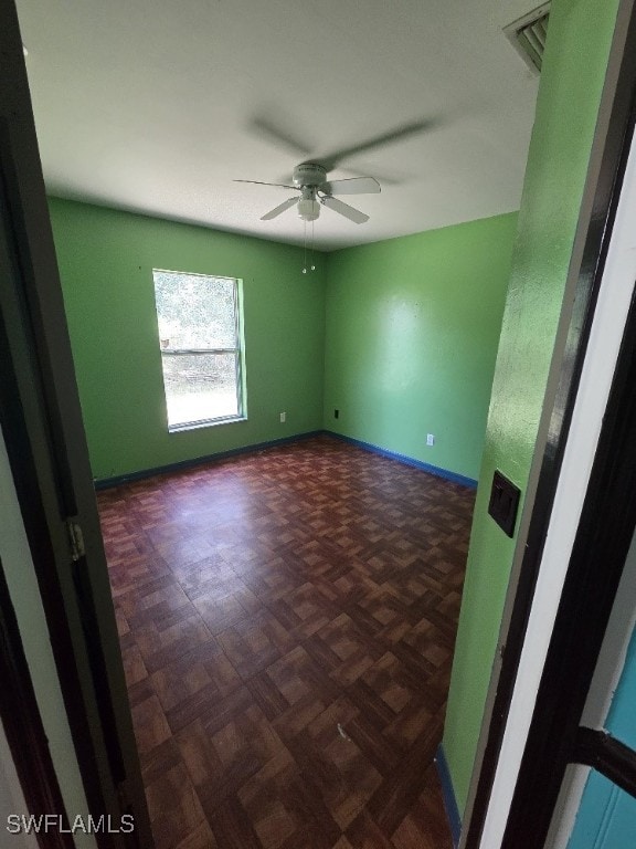 3022 34th St SW, Lehigh Acres, FL 33976 - spare room featuring ceiling fan and baseboards