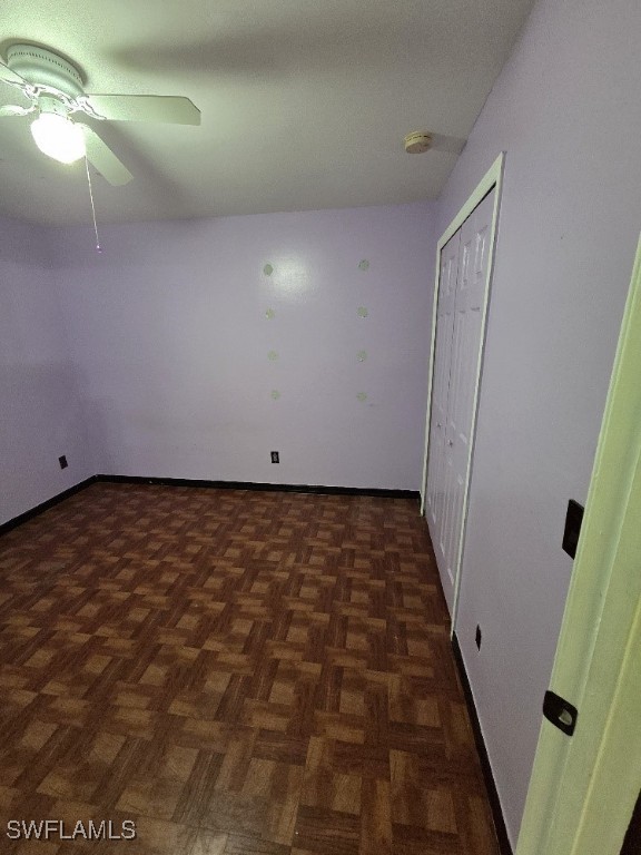 3022 34th St SW, Lehigh Acres, FL 33976 - unfurnished bedroom with a closet and a ceiling fan