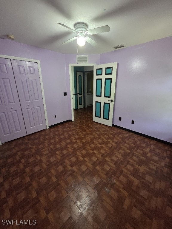 3022 34th St SW, Lehigh Acres, FL 33976 - unfurnished bedroom with baseboards and ceiling fan