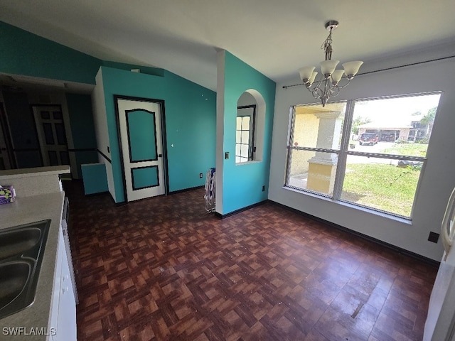 3022 34th St SW, Lehigh Acres, FL 33976 - kitchen featuring vaulted ceiling, a chandelier, and decorative light fixtures