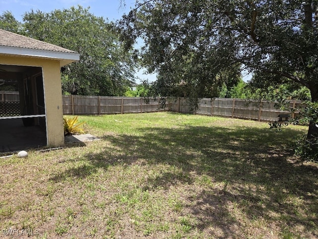 3022 34th St SW, Lehigh Acres, FL 33976 - fenced backyard featuring a sunroom