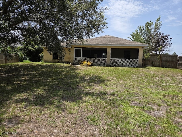 3022 34th St SW, Lehigh Acres, FL 33976 - rear view of property featuring a sunroom and stucco siding