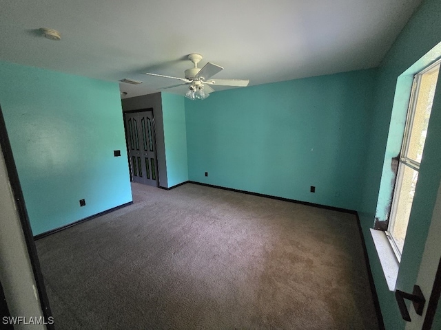 3022 34th St SW, Lehigh Acres, FL 33976 - carpeted empty room featuring healthy amount of natural light, ceiling fan, and a smoke detector