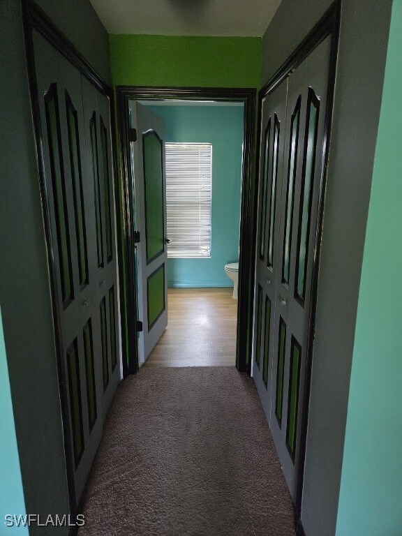 3022 34th St SW, Lehigh Acres, FL 33976 - hallway featuring light colored carpet