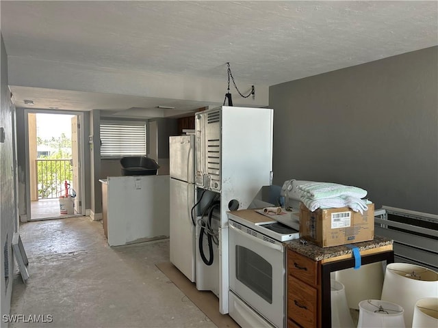 8350 Estero Blvd Unit 235, Fort Myers Beach, FL 33931 - kitchen with unfinished concrete floors and white appliances