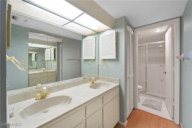 5487 Peppertree Dr Unit 5, Fort Myers, FL 33908 - bathroom featuring a stall shower, double vanity, and wood finished floors