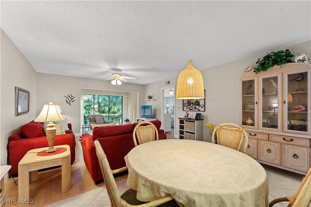 5487 Peppertree Dr Unit 5, Fort Myers, FL 33908 - dining space with light tile patterned floors, a textured ceiling, and ceiling fan