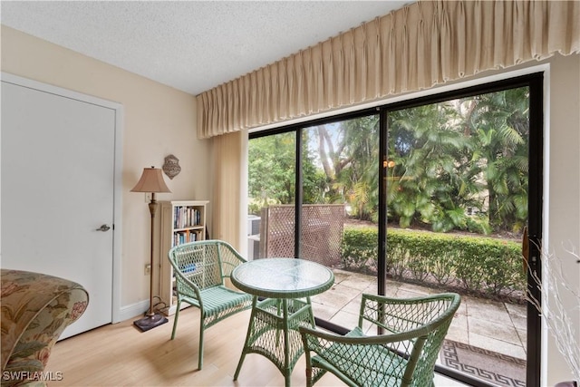 5487 Peppertree Dr Unit 5, Fort Myers, FL 33908 - dining area with wood finished floors and a textured ceiling