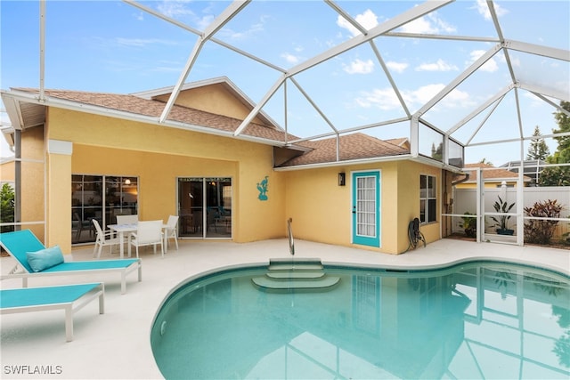 1057 Silverstrand Dr, Naples, FL 34110 - view of pool featuring a patio and glass enclosure