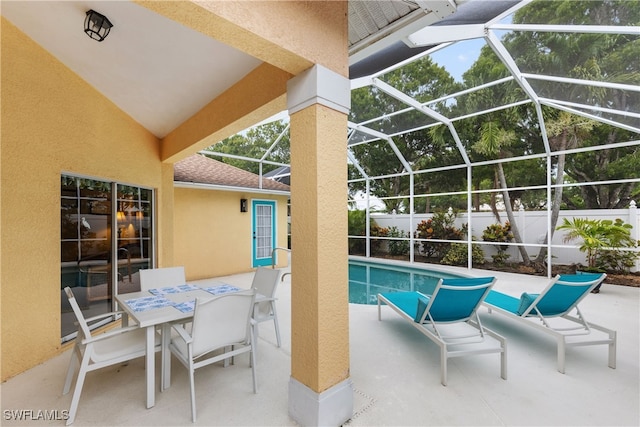 1057 Silverstrand Dr, Naples, FL 34110 - view of patio with glass enclosure and outdoor dining area
