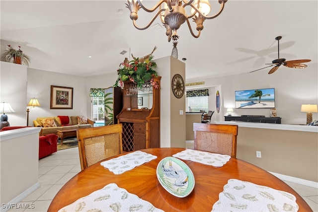 1057 Silverstrand Dr, Naples, FL 34110 - tiled dining room with a chandelier, a ceiling fan, and vaulted ceiling
